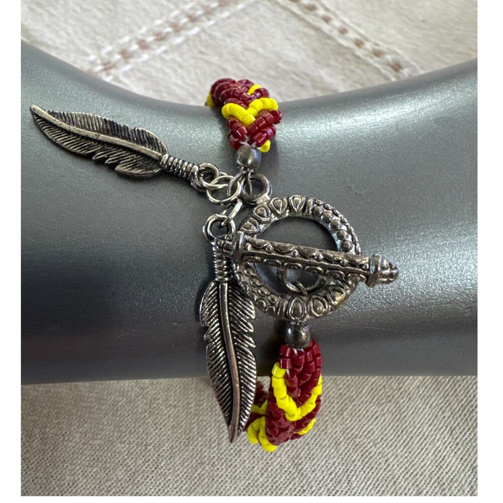 7" Burgundy, Red and Yellow Braided Beads, Silver Tone Toggle Clasp and Feathers